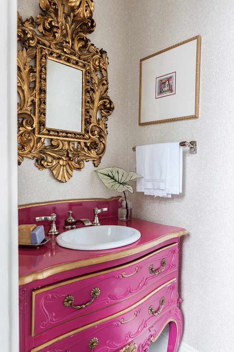 Powder room with bright pink pop of color