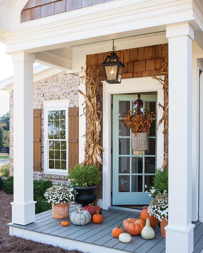 front exterior with blue door and fall decor
