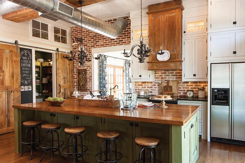 kitchen with brick backsplash and green cabinetry 