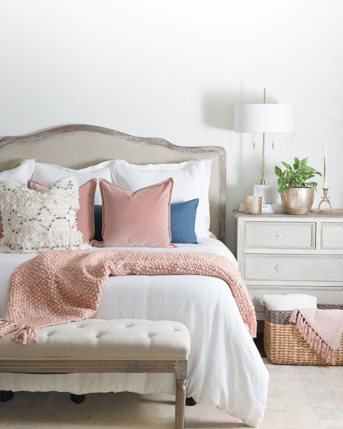 cottage bedroom with pink throw pillows