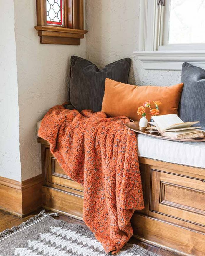 orange throw blanket and throw pillows