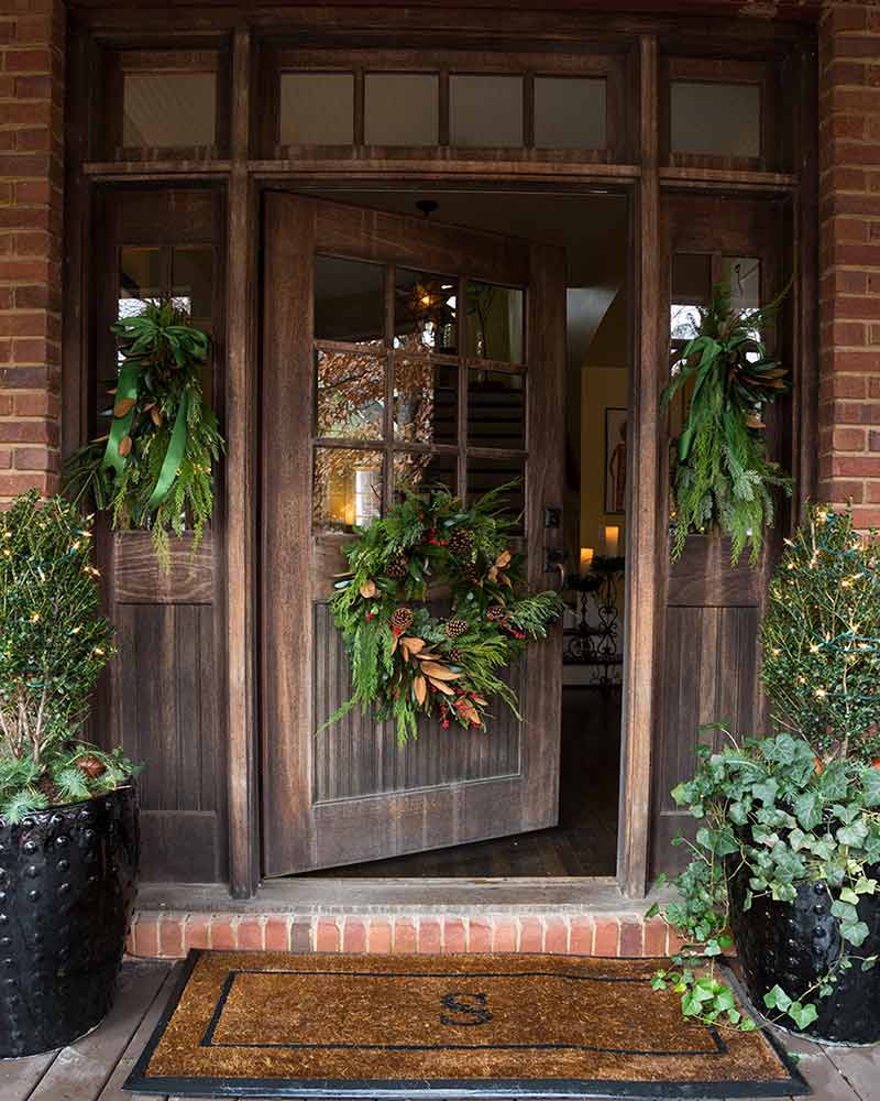 dark brown wooden front door with wreath