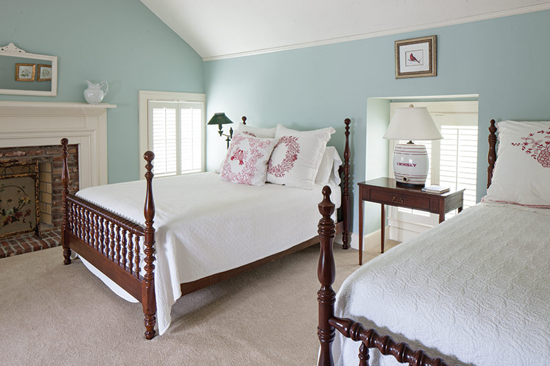 Guest suite with light blue walls and two full size beds