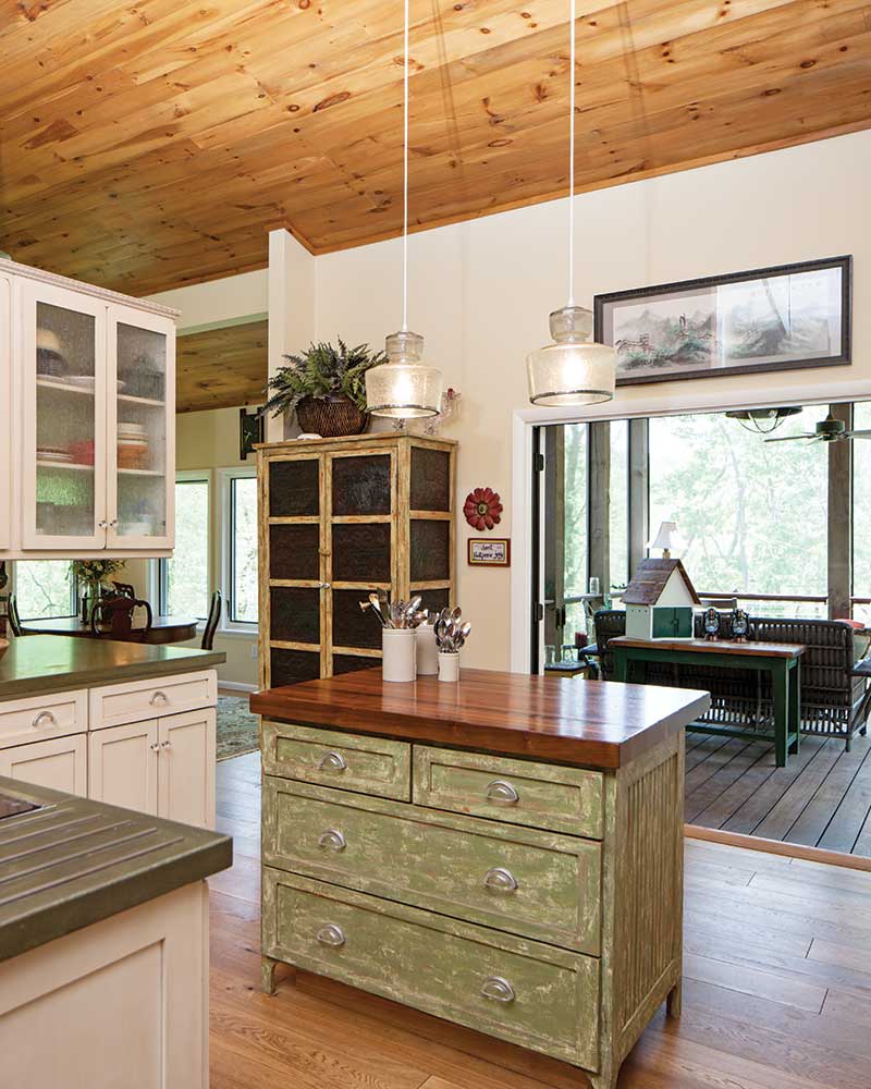 Country style cottage kitchen with green-painted island