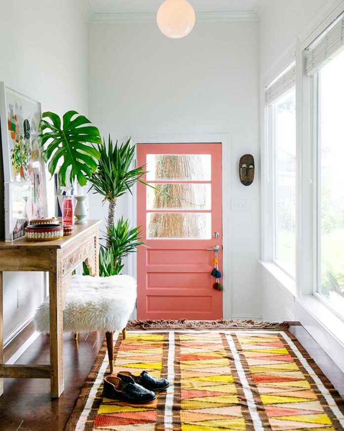 Bright boho foyer with coral door