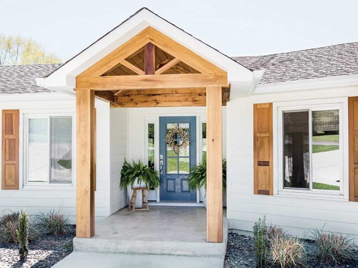 white exterior with light wood beams and blue front door