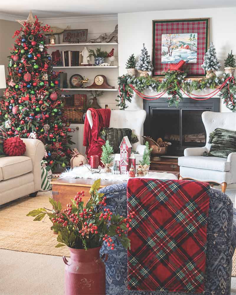 A living room decorated for Christmas with red-and-green plaid accents.