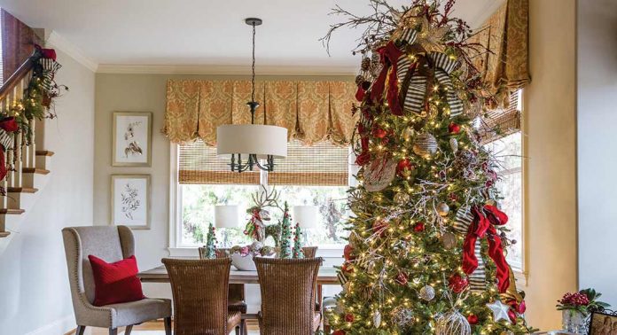 A dining area with a Christmas tree.