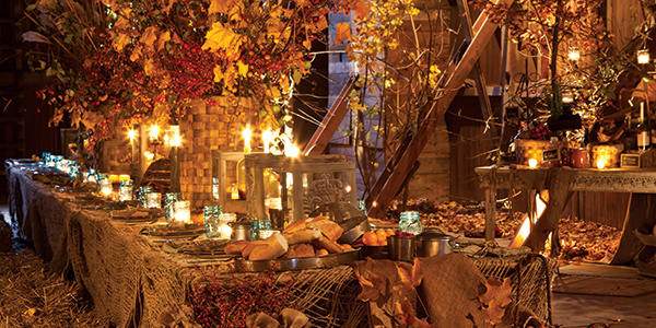 A tablescape with fall foliage and candles.