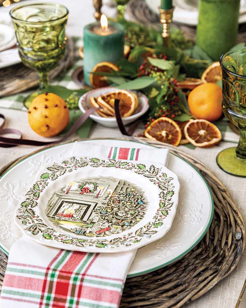 Place setting with plaid napkin and dried orange slices. 