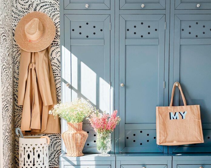 A mudroom with blue cabinetry.