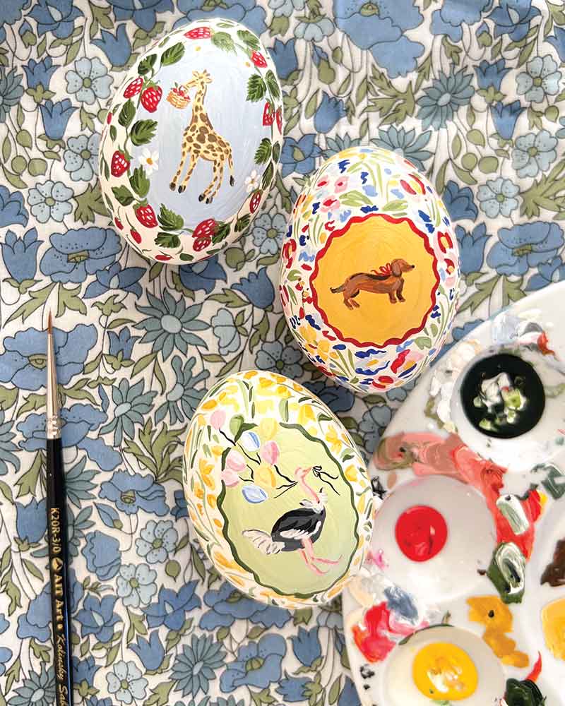 Three painted eggs on a floral background.