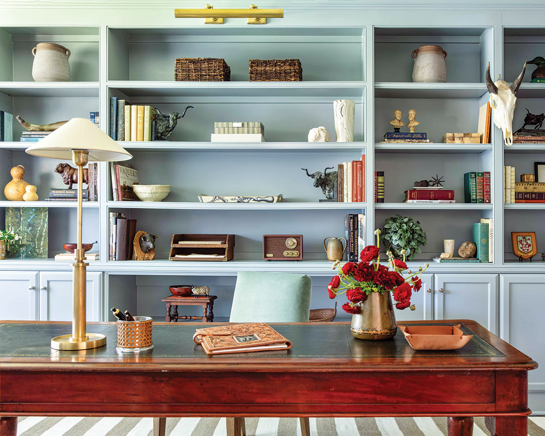 An office with built-ins painted a mint blue. 