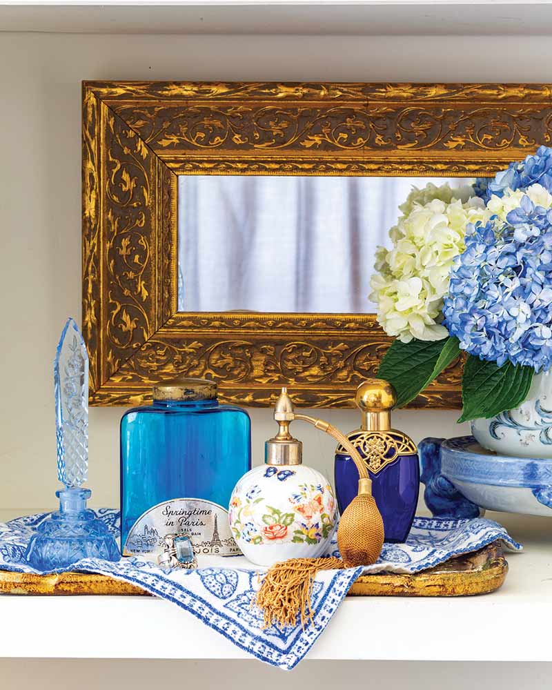 A collection of blue antique perfume bottles.