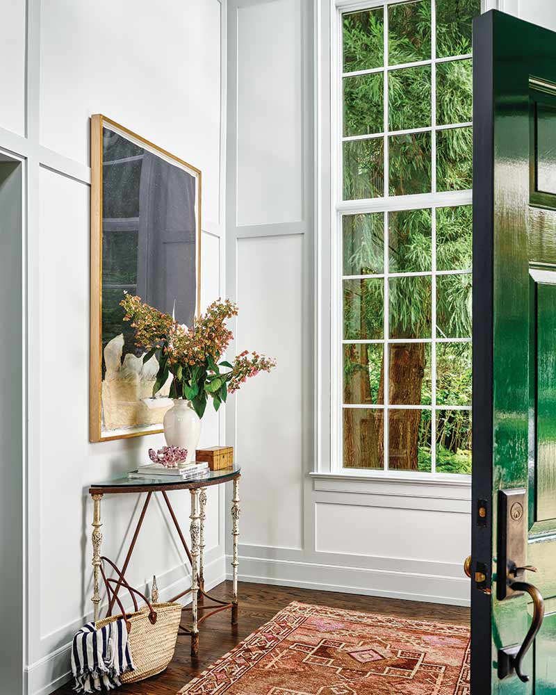 An entryway with board and batten walls and a small console table.