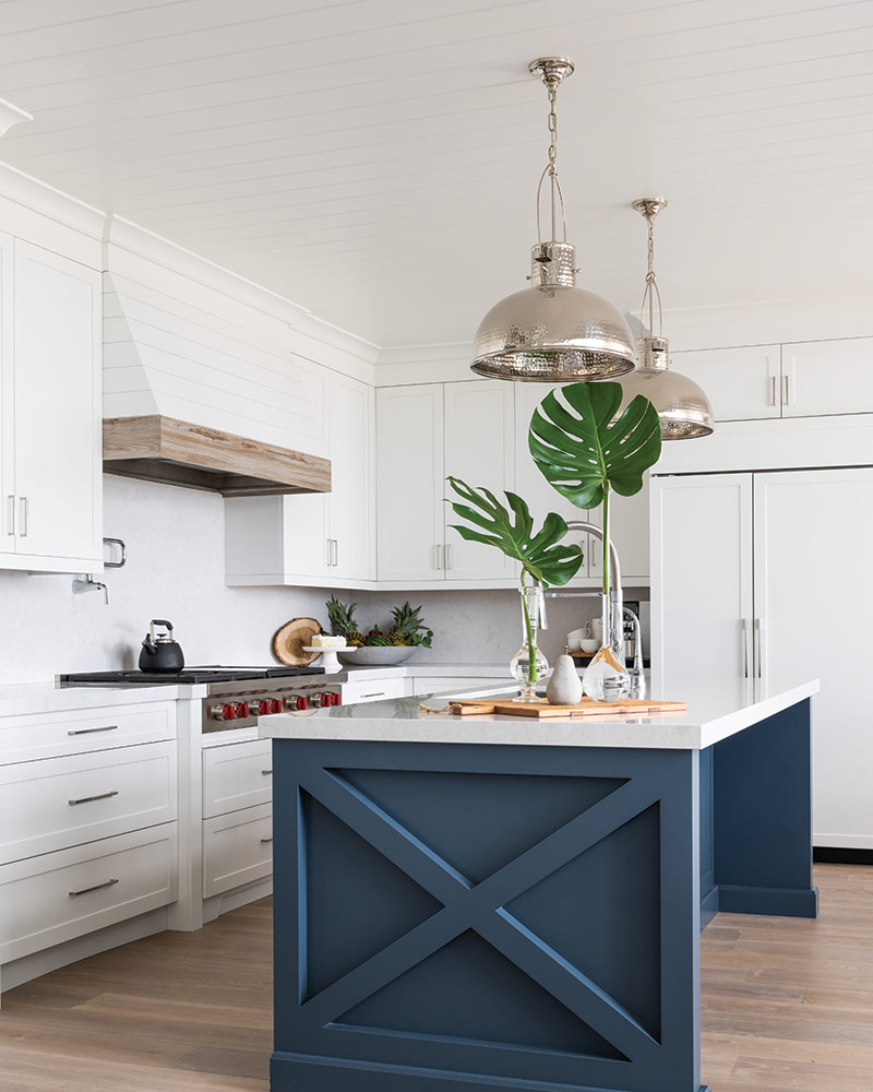A kitchen with a blue island.