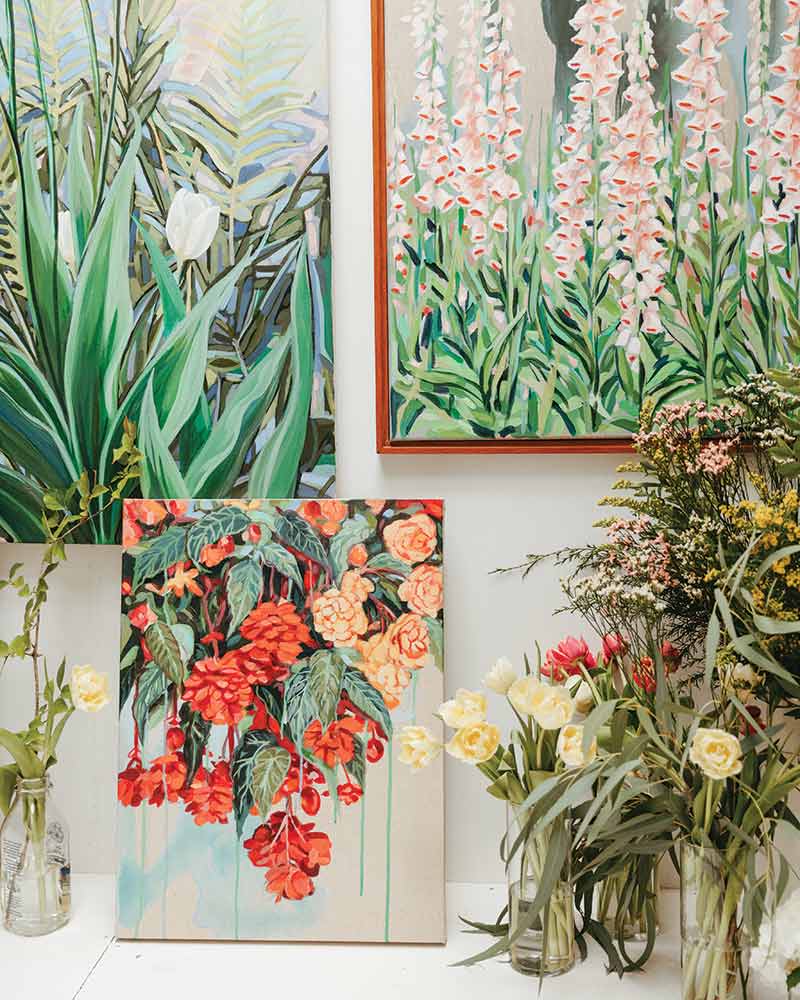 A grouping of floral paintings.