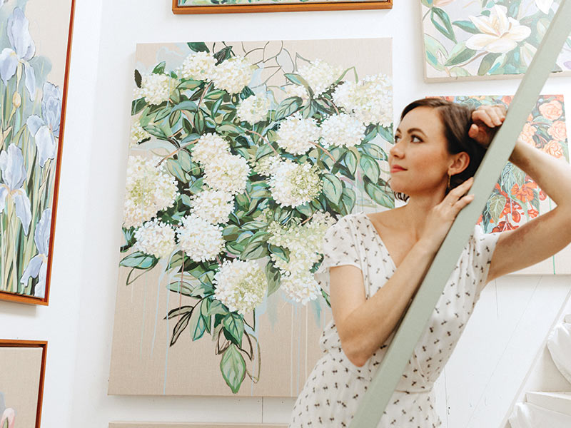Artist Meredith Raiford posed with her floral painting.