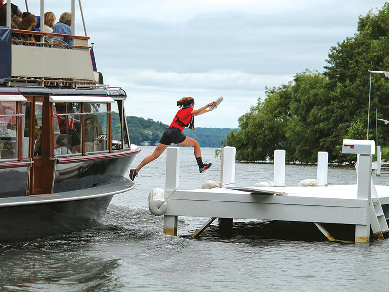 A girl delivering mail on Lake Geneva Cruise Line’s U.S. Mailboat tour. 