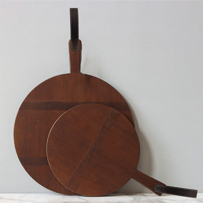 Two round dark wood charcuterie boards.