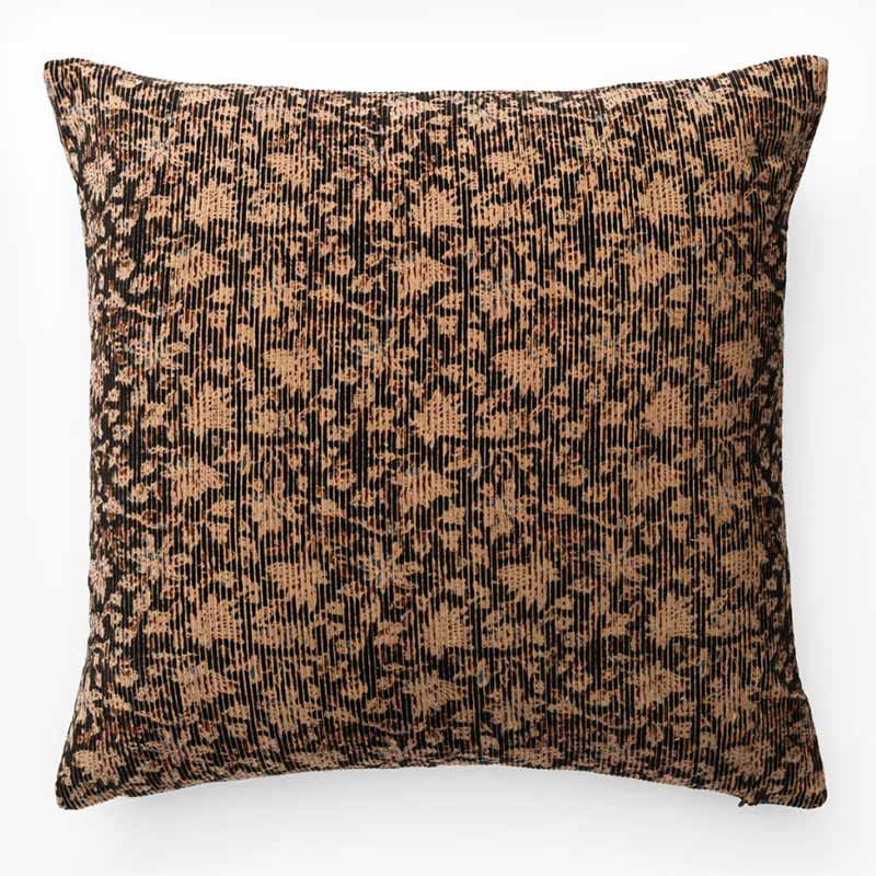 A velvet block print pillow cover in black and brown hues.