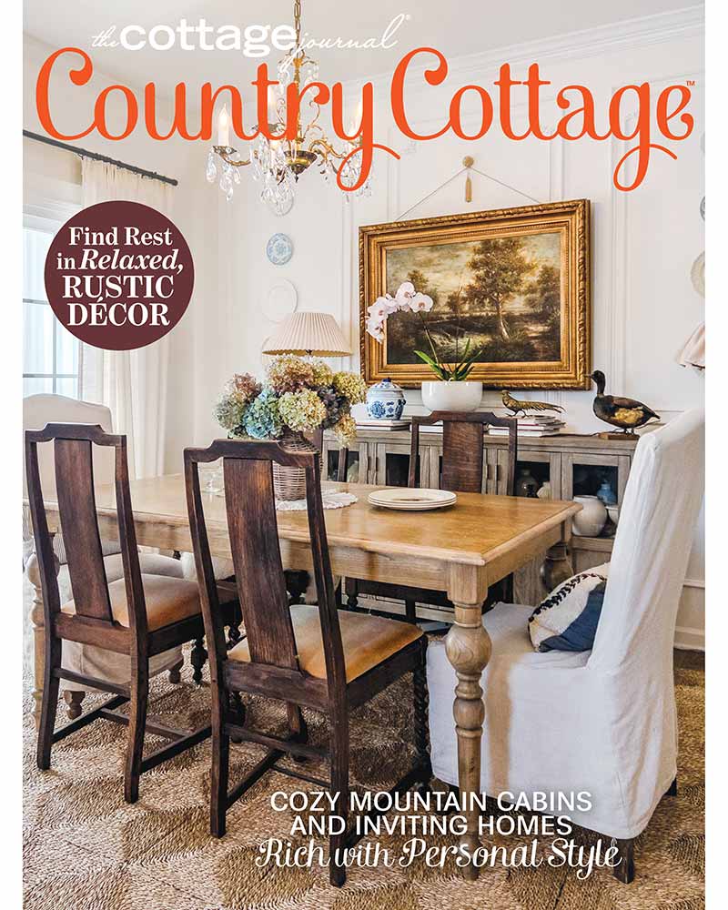 The cover of Country Cottage 2024 featuring a dining room with vintage furnishings.