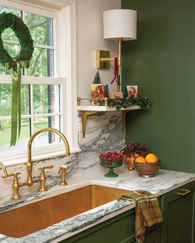 During the holidays, miniature wreaths hang delicately on the windows with simple green ribbons to match the cabinet color.