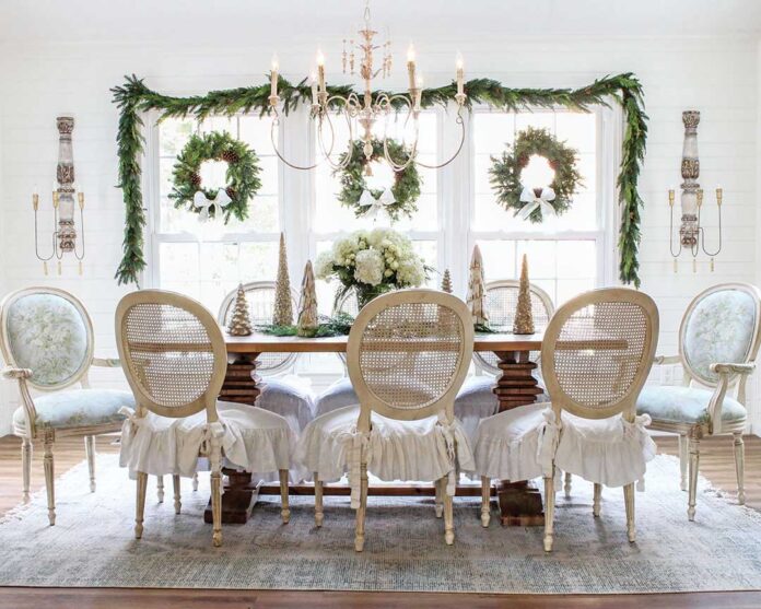 The dining room and kitchen are light and airy with neutral aesthetics that Courtney keeps simple and organic during the holidays, using greenery, flowers, and a few classic accompaniments such as tabletop trees and Christmas china.