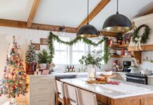 Vintage Christmas Charm Abounds in This Dream Farmhouse Sweet treats create an alluring centerpiece on the kitchen island, and greenery graces everything from the sink to the range hood.