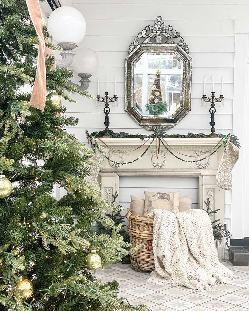 To emphasize the room’s indoor-outdoor feel, Natalie decorated with rustic, antique pieces, including a mantel featuring intricate carvings.