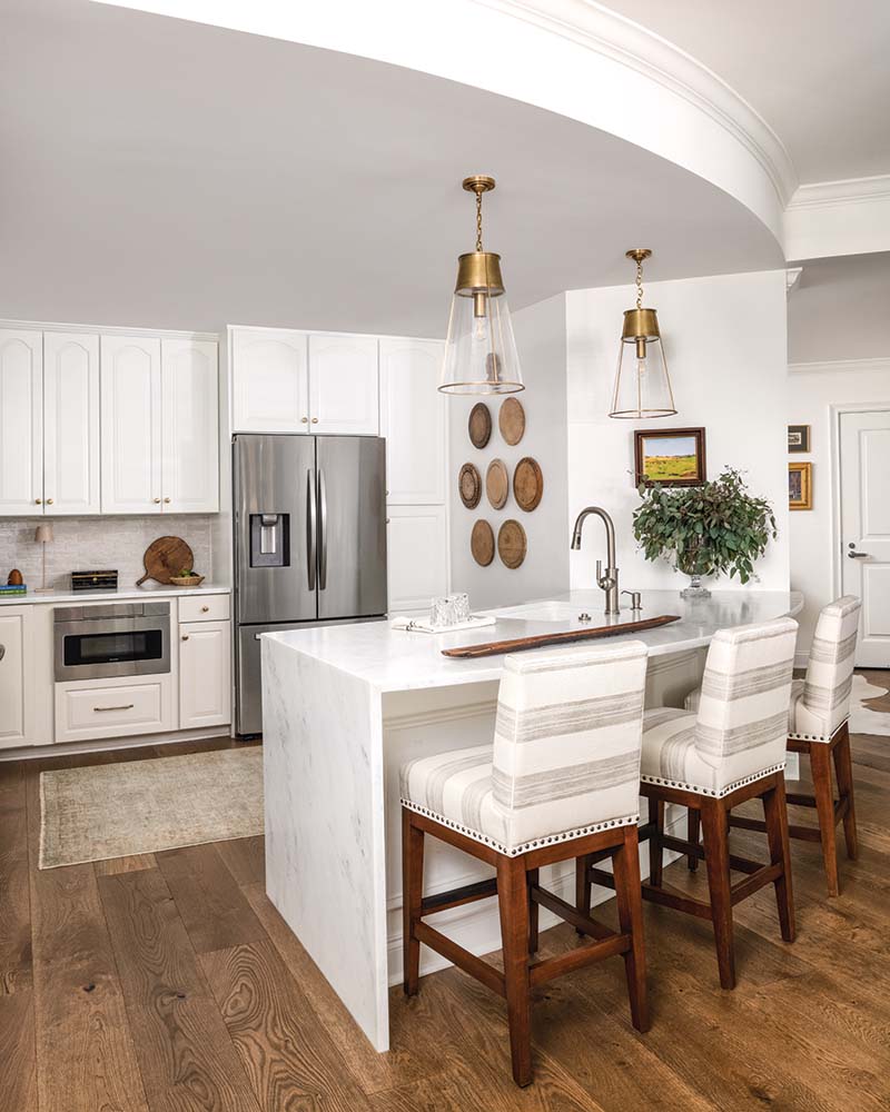 Circa Lighting pendant lights hang above the new bar in the kitchen, paired with barstools in a Perennials fabric.