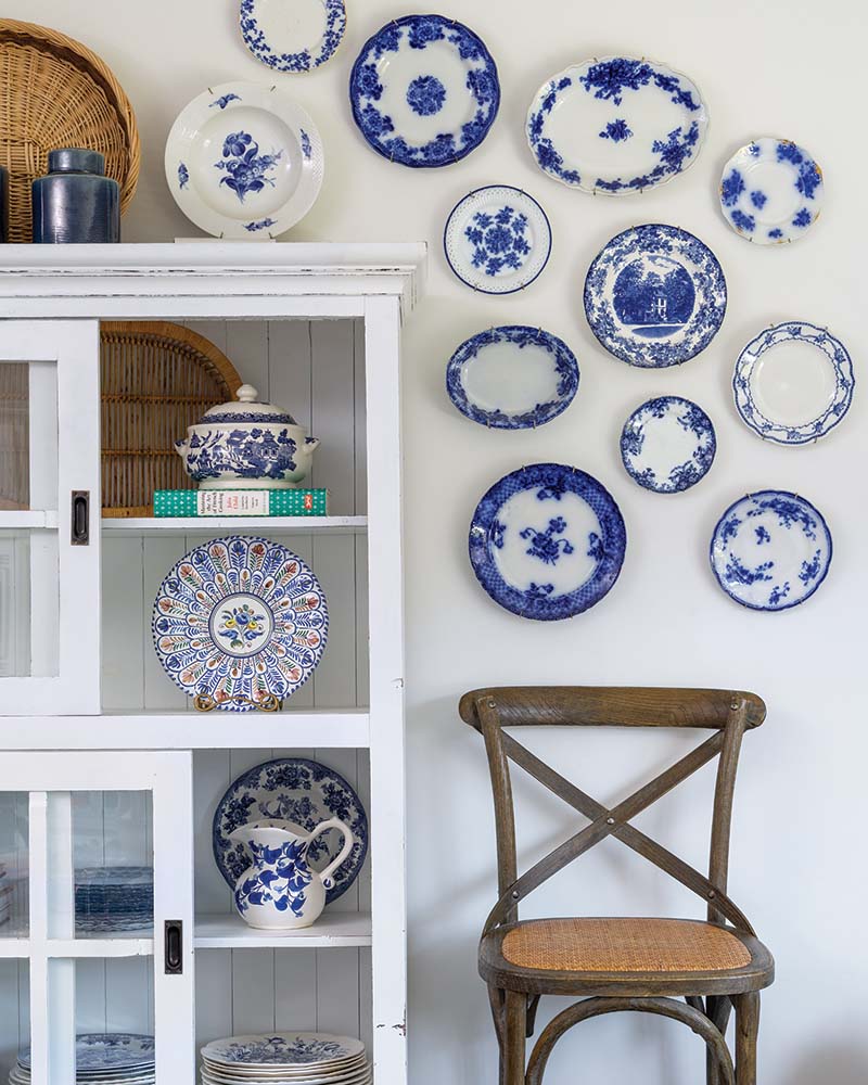 While the home’s open floor plan doesn’t leave much wall space in the kitchen, Mary Lee made the most of what she had, repurposing a bookcase that’s been in the family for years as a china cabinet that shows off both collected vintage pieces and the family’s everyday dishes.