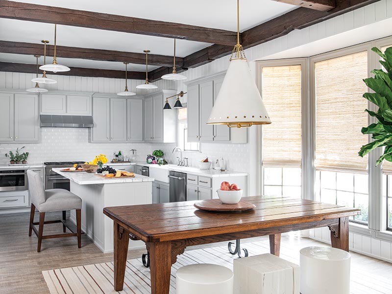 The breakfast area off the kitchen features one of the few pieces the family brought with them into the home—a wooden table Katie and Robert Martin created themselves.