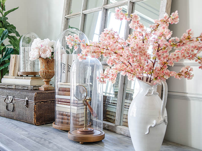 Whether by nestling them beneath a glass cloche or turning them to display their aged pages, get creative when it comes to presenting antique books in stacks.