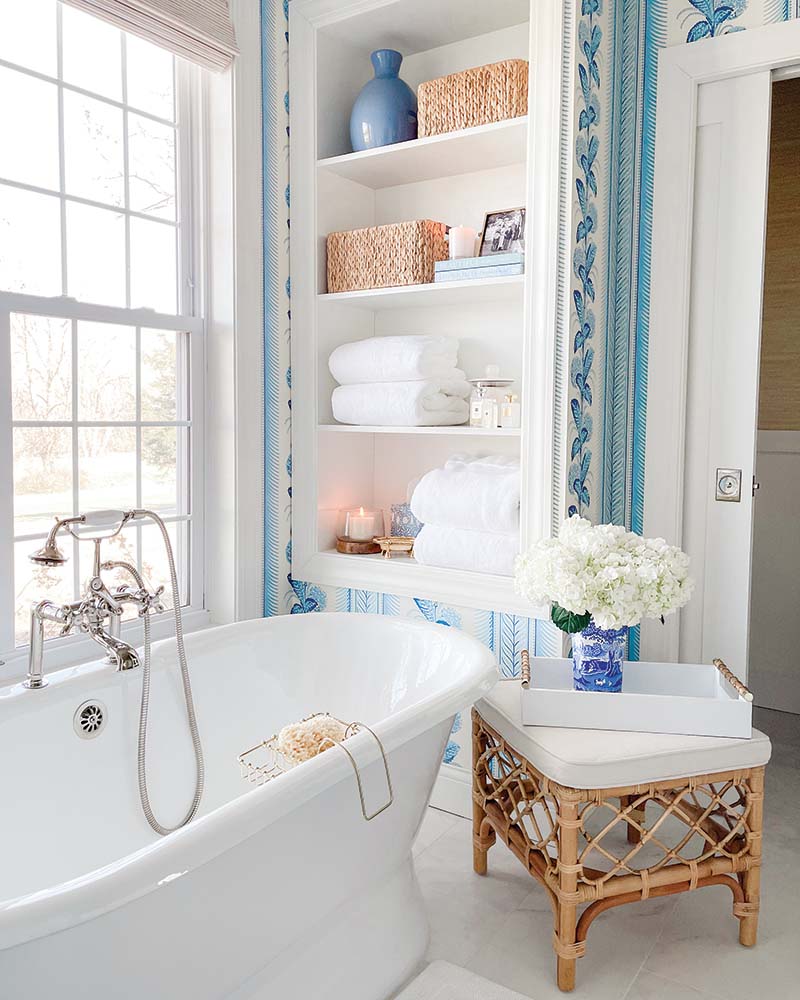 One of the spaces that was transformed the most, the primary bathroom is now a haven of elegance and serenity—owing in large part to the Quadrille Climbing Hydrangea wallpaper that lends the space its color.