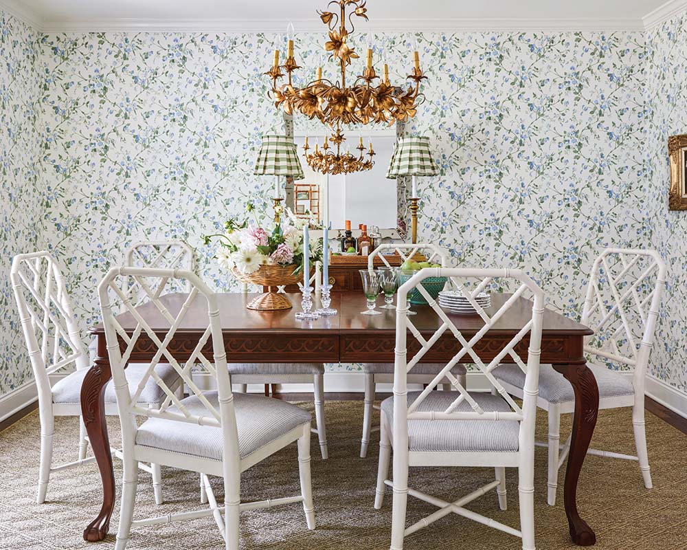 A fanciful blue-and-green floral wallpaper graces the dining room’s walls. The gathering spot plays host to both everyday family meals as well as wine tastings with friends.