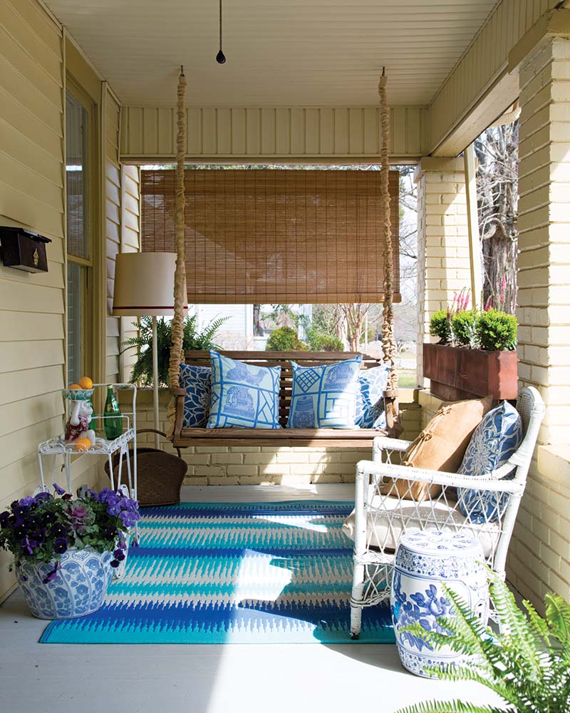 Her unique style is first seen on the front porch, where the outdoor furniture is upholstered with textiles from Mary Catherine’s store, Cotton & Quill.