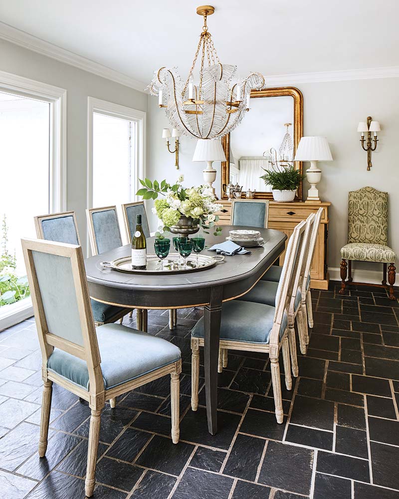 The modern chandelier from Visual Comfort is the crowning jewel on a dining room that thrives on vintage style. The gold finish of its elegant curving arms perfectly echoes the frame of Minnette’s beloved mirror.