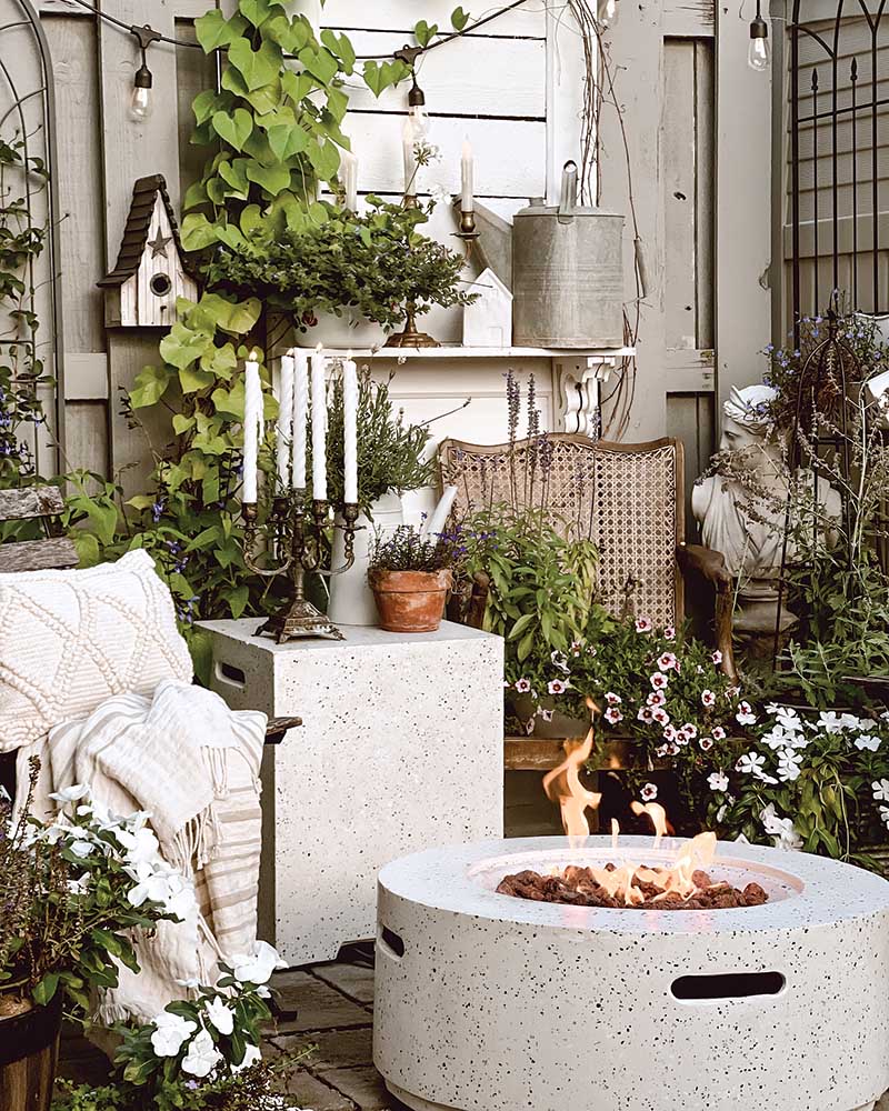 Featuring the same layered approach as is seen in the indoor spaces, the petite patio is a favorite spot for the Johnsons come summertime. A firepit ensures they can enjoy the space well into fall. The plethora of potted plants allows SJ to pursue her passion for planting through container gardening.