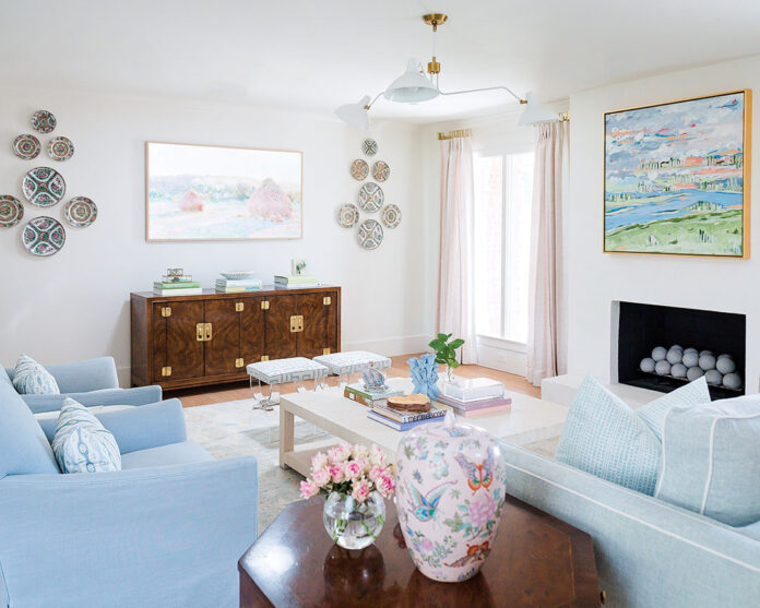 A contemporary grass cloth coffee table, which ties in the entry walls, provides a soft focal point amid darker wood fixtures that all boast storied pasts.