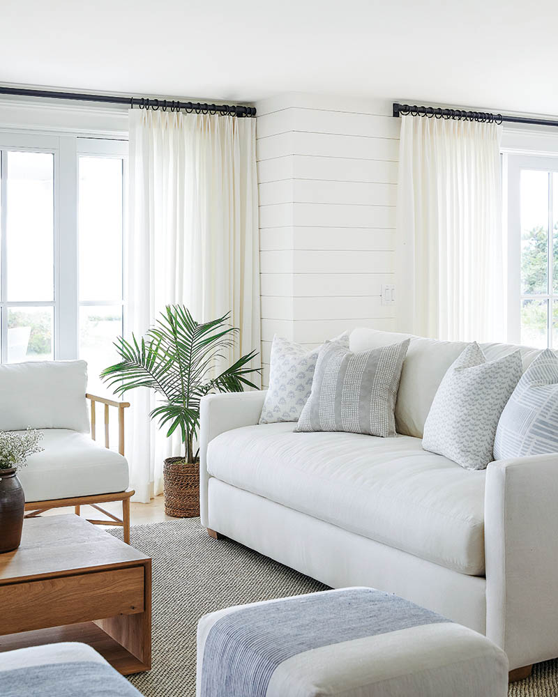 Furniture spanning both traditional and contemporary designs is streamlined but comfortable with plush upholstery and accompanying textiles bearing restrained yet varied patterns, such as nautical-inspired stripes and abstract motifs, along with muted color.