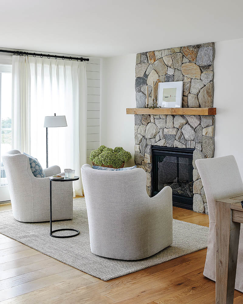 The living area features a floor-to-ceiling stone fireplace.