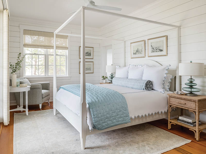 With its soothing seaglass palette, the bedroom features a timeless four-poster bed draped in luxe linens.