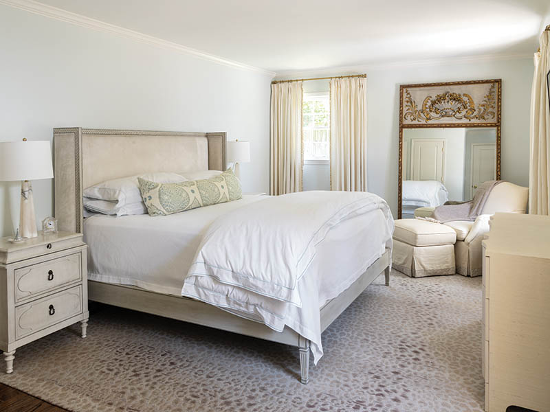 The design of the primary bedroom took into account the antique French mirror the couple already owned.