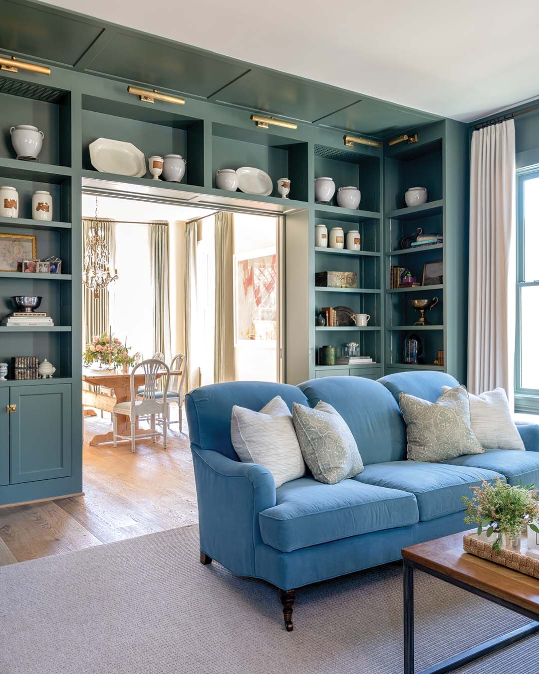 The family room boasts a bold green shade that makes evenings spent in the space even cozier.