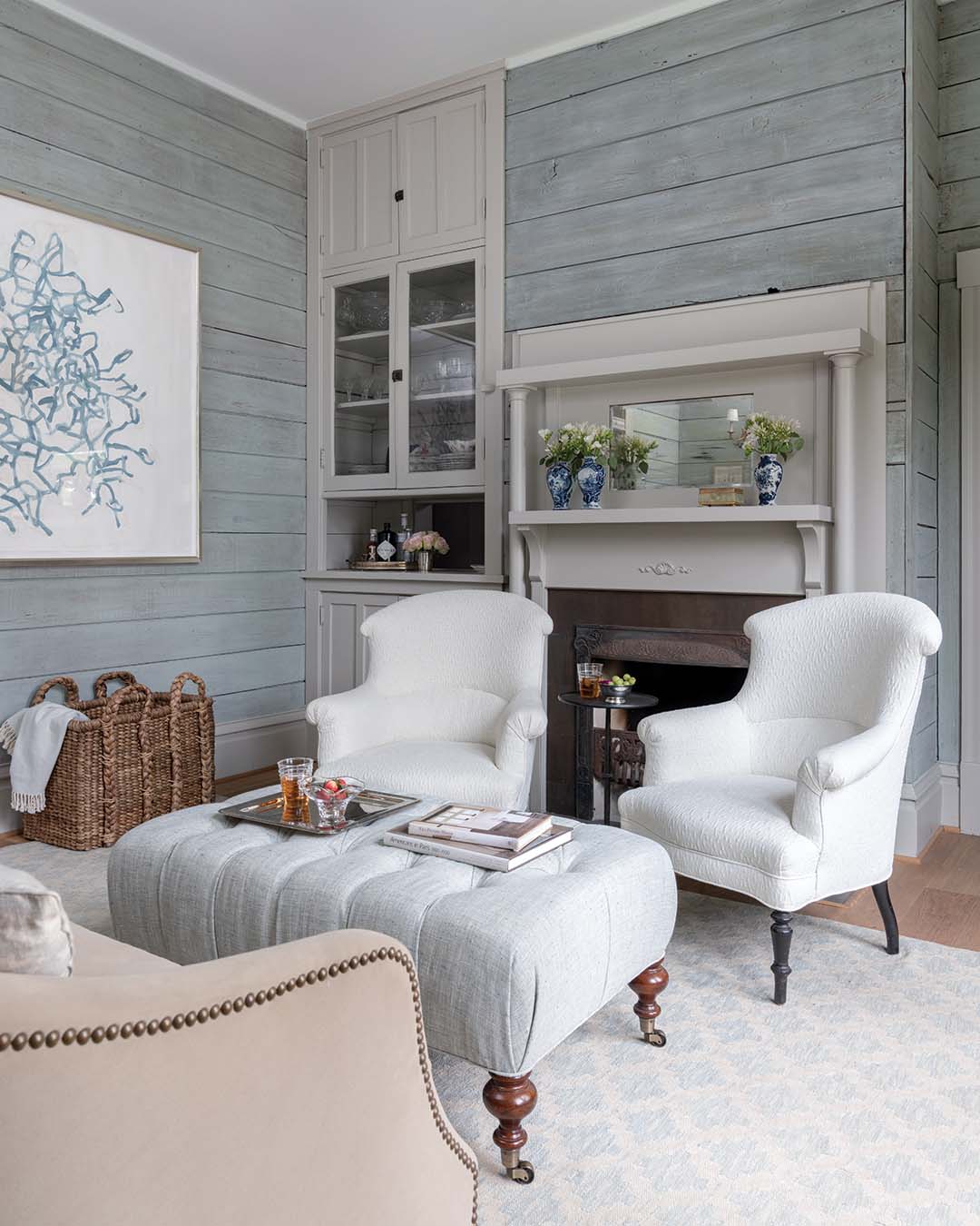 Napoleonic chairs were recovered in a textured fabric for the formal living room and paired with a custom sofa and ottoman.