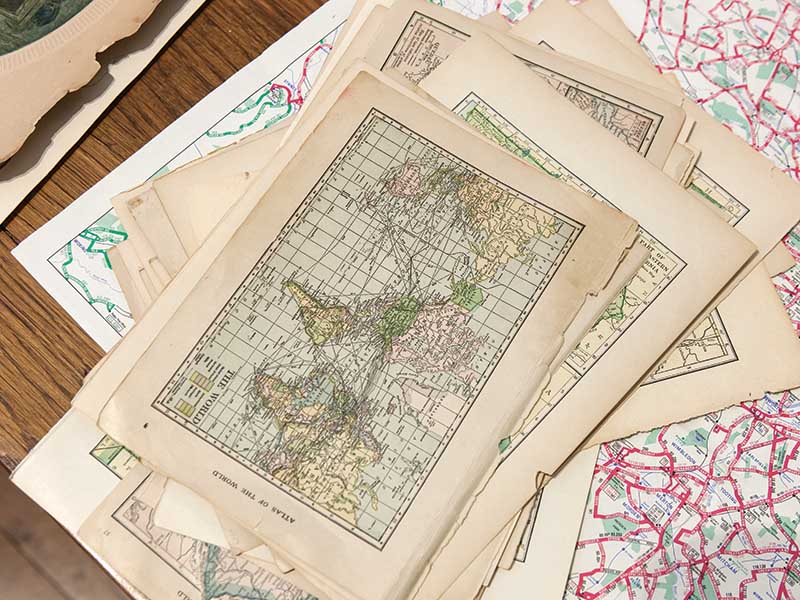 Open a window to the past with vintage maps, weaving tales of cherished memories between past and present adventures.