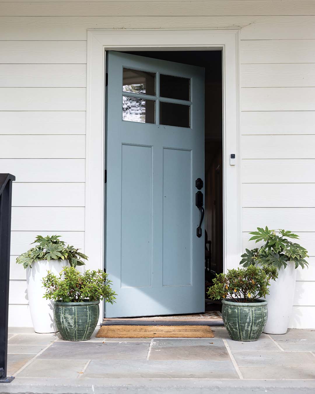 Leigh integrated shades of blue throughout the home, including on the front door.
