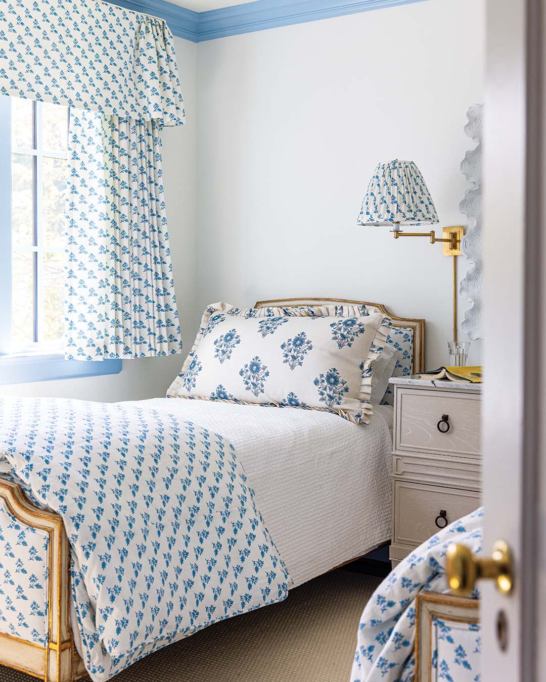 A classic color combination, blue and white make their reappearance in the guest bedroom, where Caroline utilized scale to maximize visual impact while maintaining a cohesive look.
