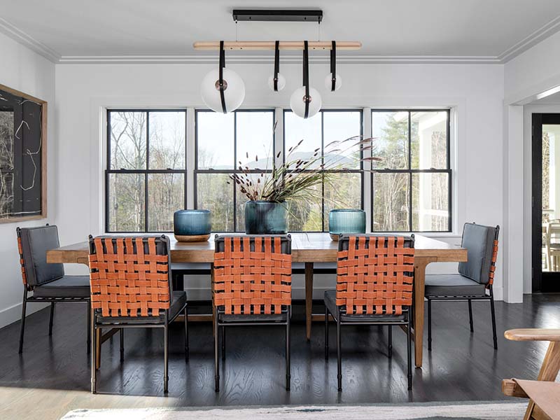 A Hubbardton Forge pendant light tops off the dining area with an artistic flair, showing off the design team’s penchant for selecting showstopping light fixtures.